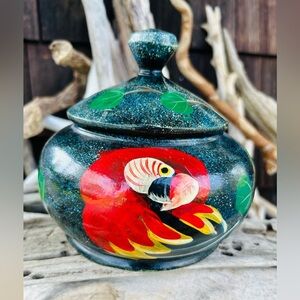 Hand Painted Wooden Jar with Red Macaw Parrot and Tree Design against a Dark Sky